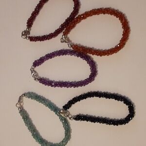 Five genuine gemstone bracelets.